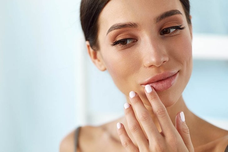 Lips Skin Care. Beautiful Woman With Beauty Face Applying Lip Balsam, Lipbalm On Full Sexy Lips. Portrait Of Smiling Female Model With Soft Skin And Natural Nude Makeup Touching Lips. High Resolution