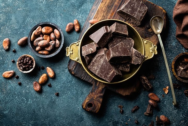 Dark chocolate pieces crushed and cocoa beans, top view